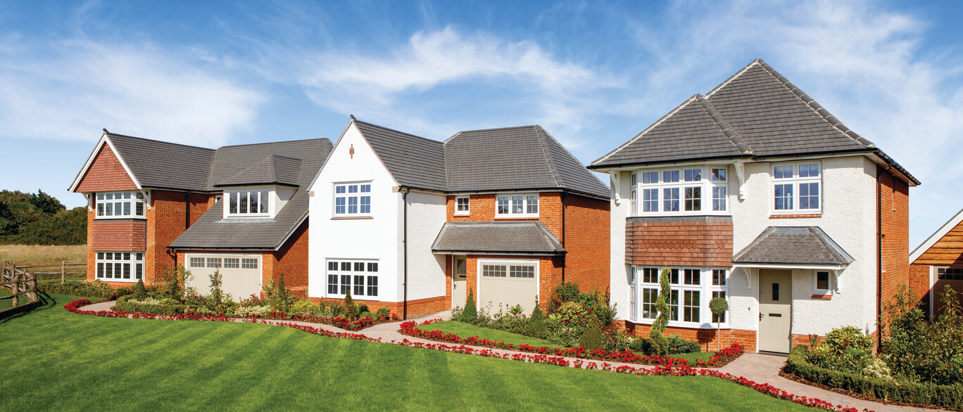 Row of modern detached houses with manicured lawns and colourful flower beds under a blue sky in Gillingham Meadows.