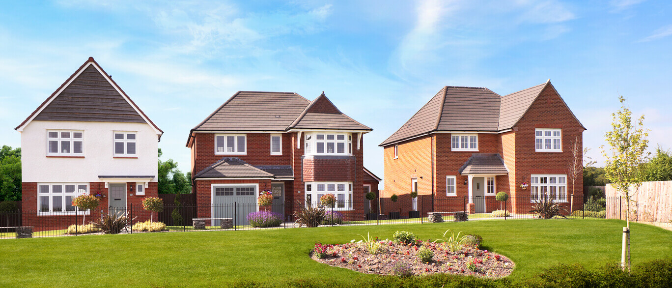 Three modern detached houses with well-maintained front gardens and a colourful flowerbed under a blue sky at Blossom Park.