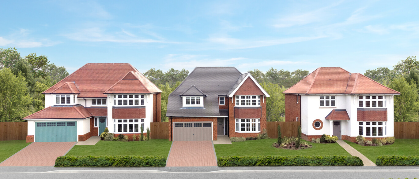 Three modern detached houses with front gardens and driveways, set against a green wooded background on a bright day at The Parklands at Great Wilsey Park.