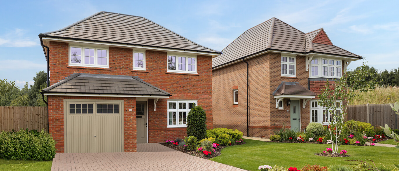 Two modern brick houses with tiled roofs and well-maintained gardens, located in a suburban area under a blue sky at Eagle Gate at Amington.