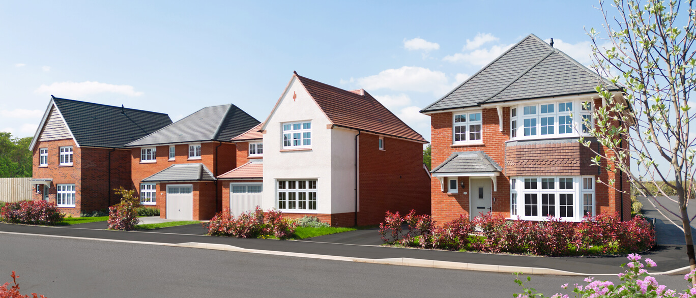 Modern detached houses with brick and white exteriors, gardens, and driveway on a sunny day at Kings Moat Village at Emperor Park at Kings Moat Village.