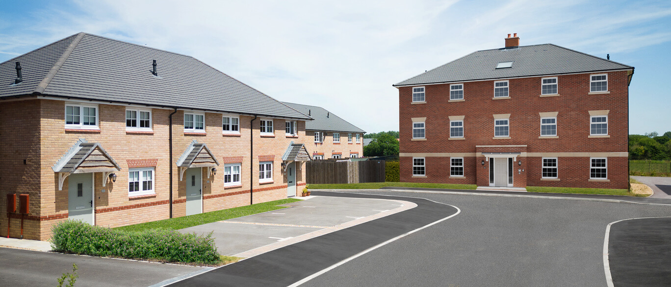 Modern residential houses with brick exteriors, grey tiled roofs, and designated parking bays in a newly developed neighbourhood at Kingsbourne.