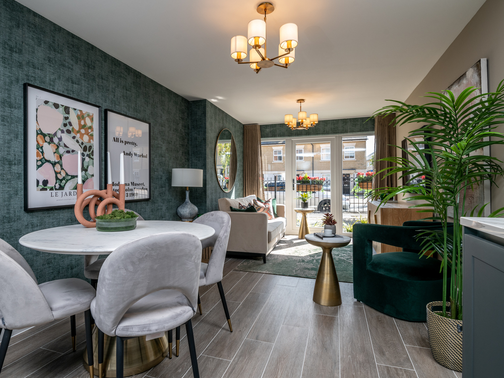 Image of open-plan apartment layout showcasing the open-plan layout of the dining area leading into the cosy lounge area with French doors