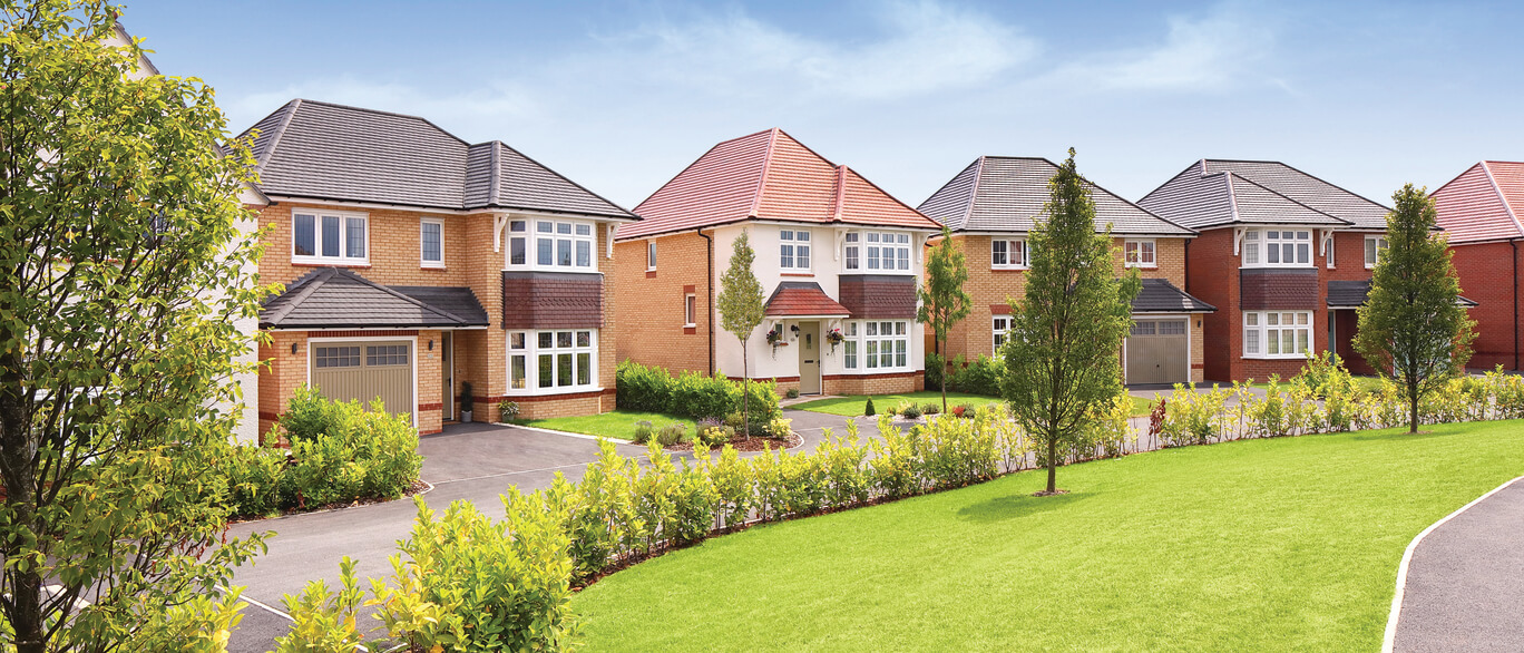 Aerial view of a modern residential neighbourhood with houses, roads, and green spaces in a rural setting under blue sky at The Landings.