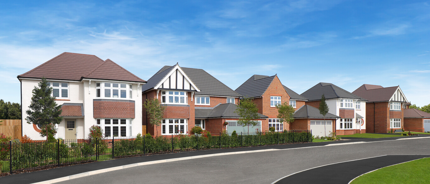 Modern suburban houses with varied brick and white exteriors, lush gardens, and a curved road under a clear blue sky.