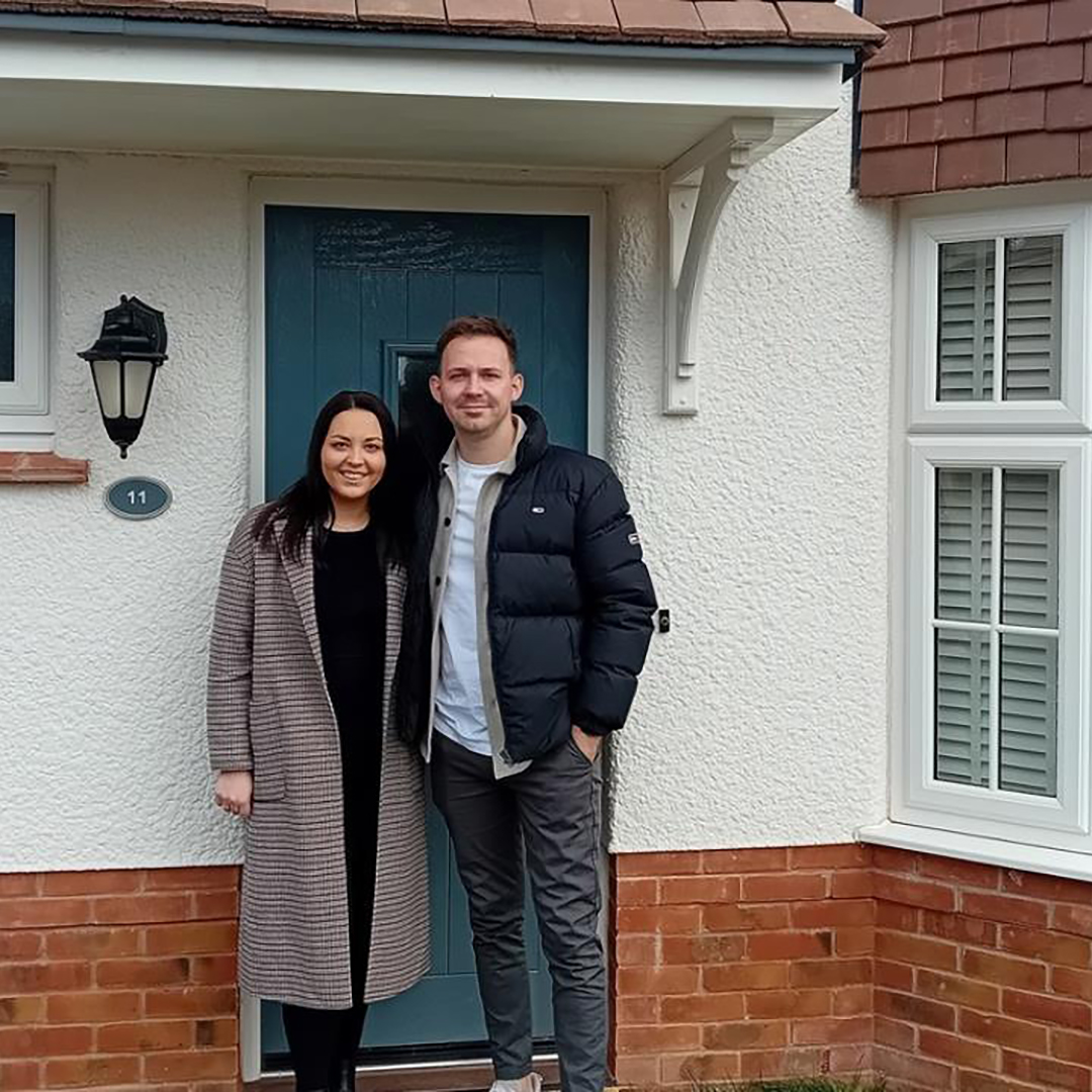 Emily & Nathen outside their new home in St Michael's Meadow