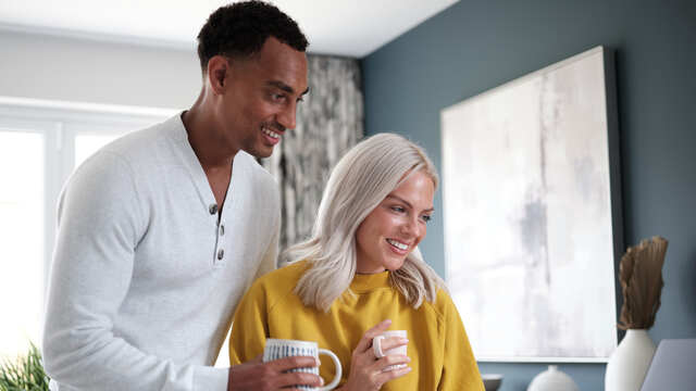 Happy couple with hot drinks