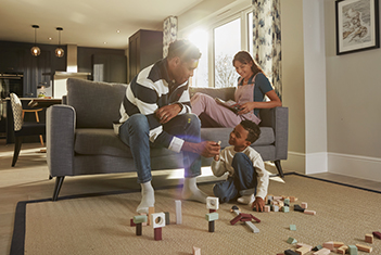 Family playing and relaxing in open plan Kitchen, dining, family room