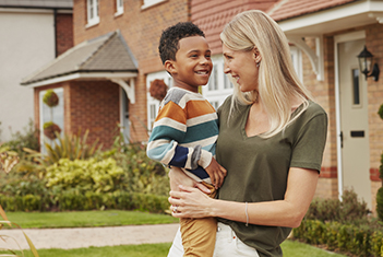 Mother and son outside their new home