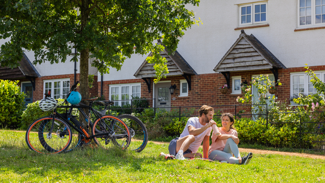 Couple resting by Heritage homes with their bikes