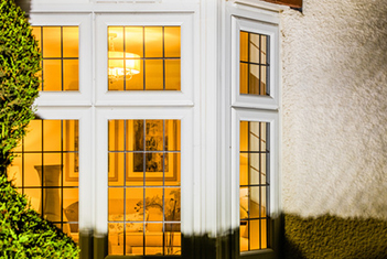 Cosy Heritage home window at night with lights on