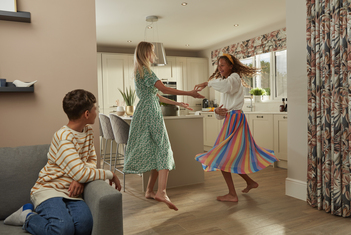 Two women dancing bare footed with underfloor heating