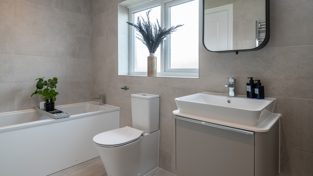 Modern bathroom with floor to ceiling tiles and countertop basin