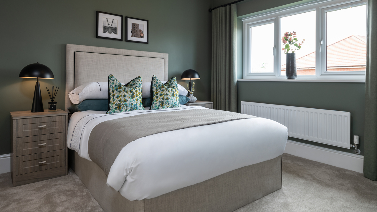 Bedroom with dark green walls 