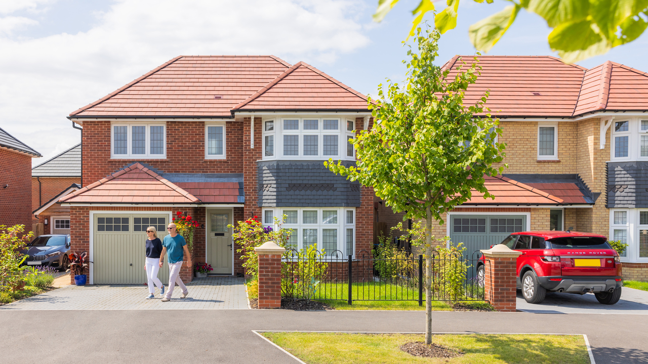 Two people walking away from their house