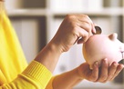 Hands holding a piggy bank