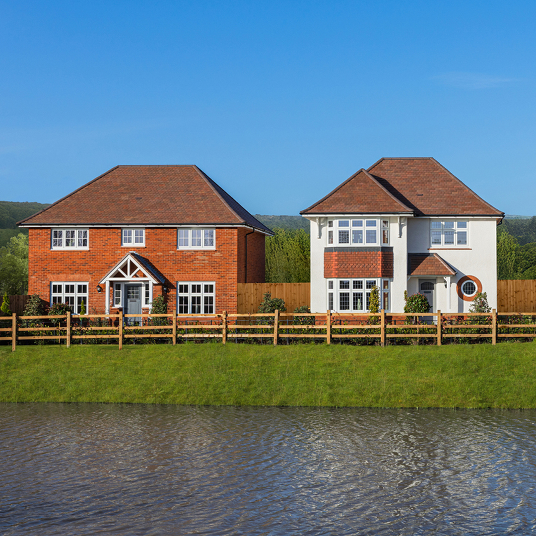 Detached homes opposite open space and a lake