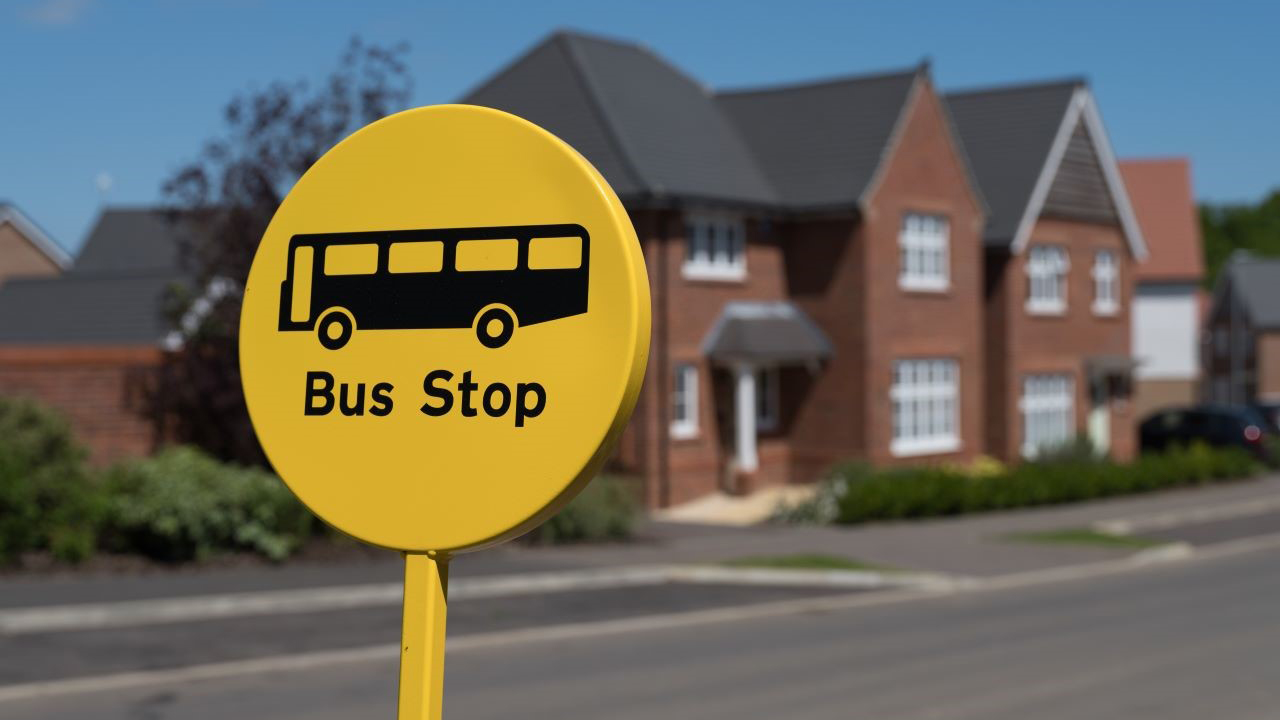 Bus stop sign outside heritage homes