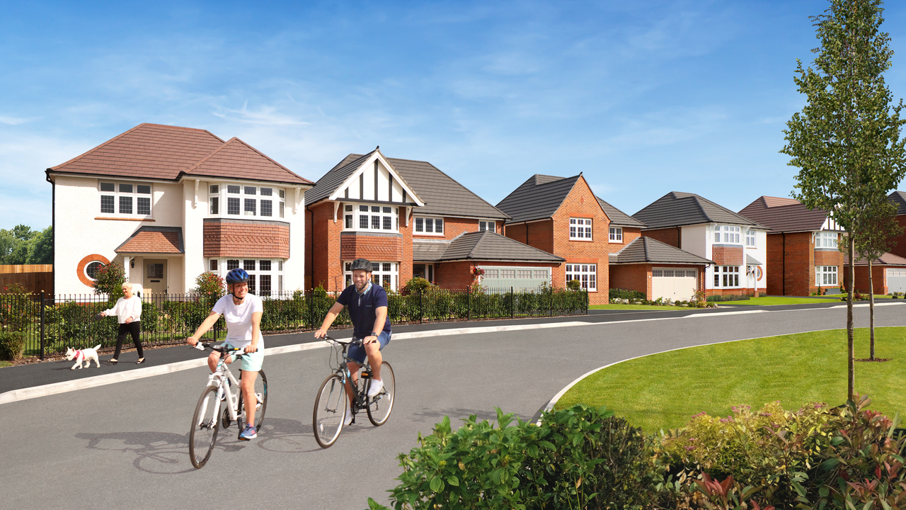 2 Cyclists ride through a Redrow development