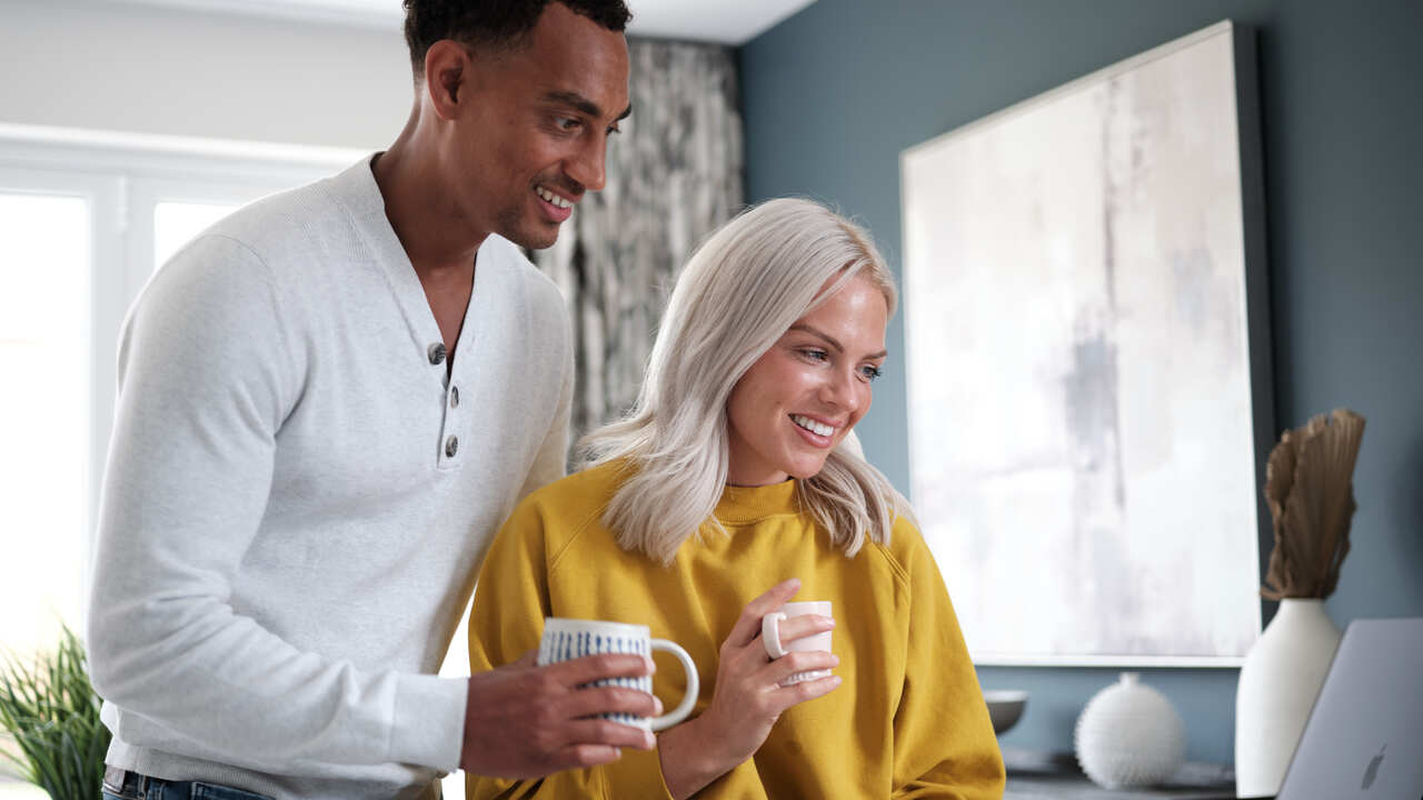Couple looking at a laptop together