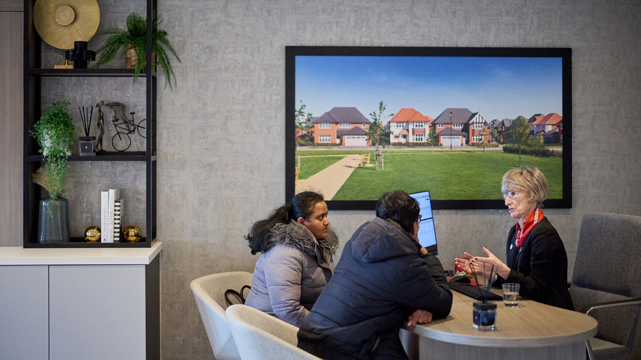 A couple speaking with a Redrow expert