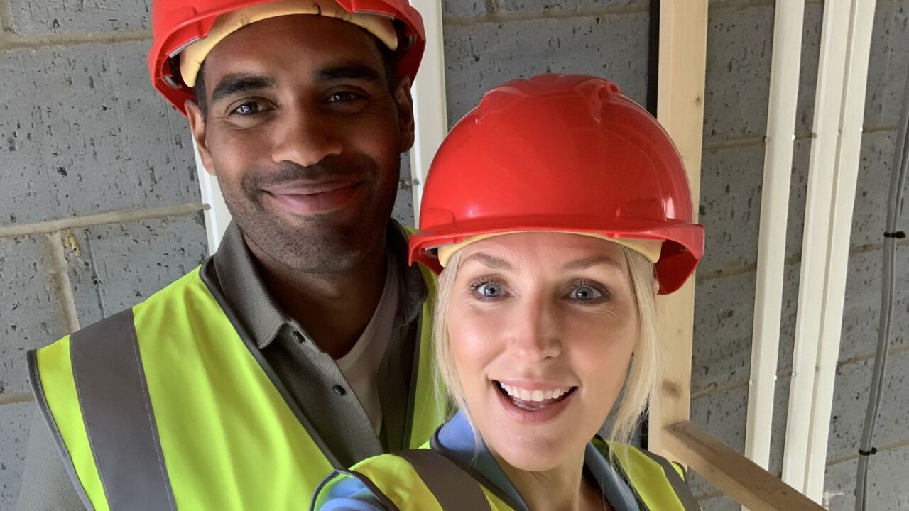 A couple wearing hard hats on their first home inspection