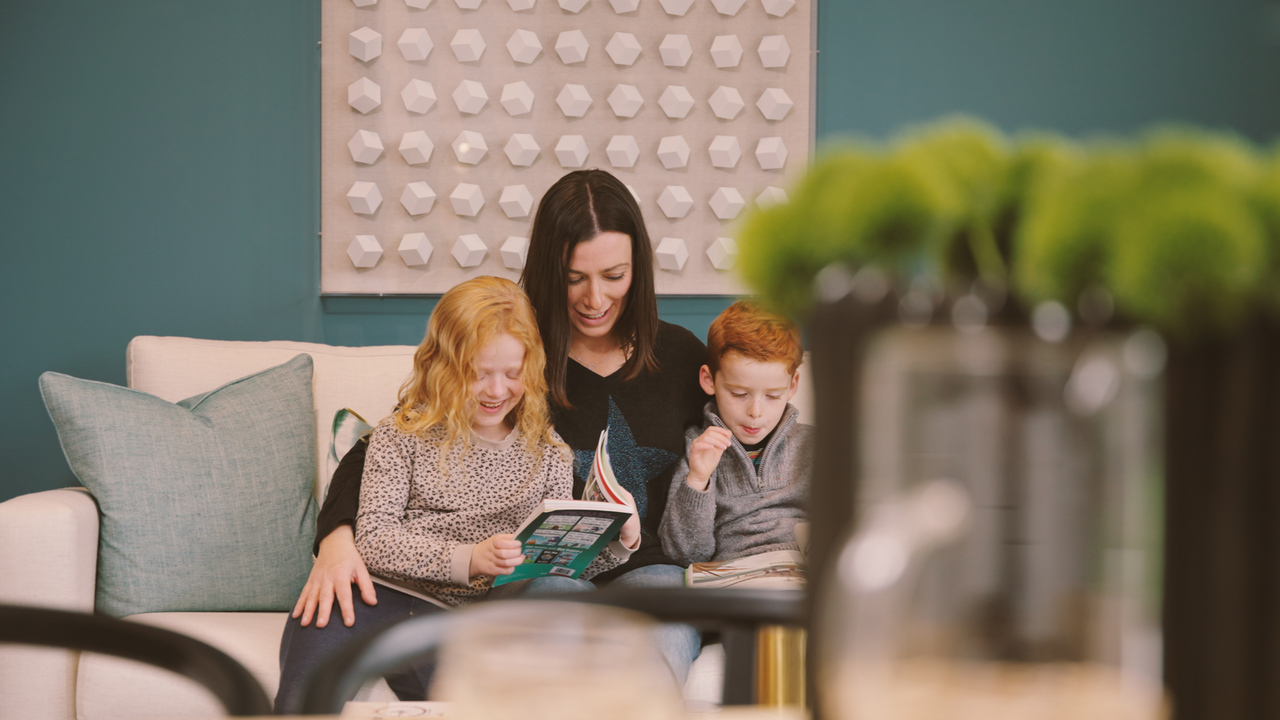 Woman reading with two children