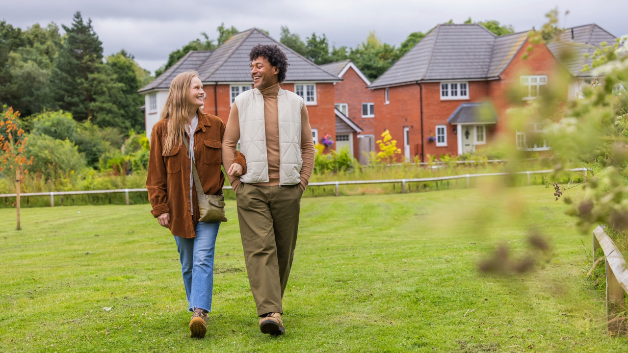 Couple walking through a field