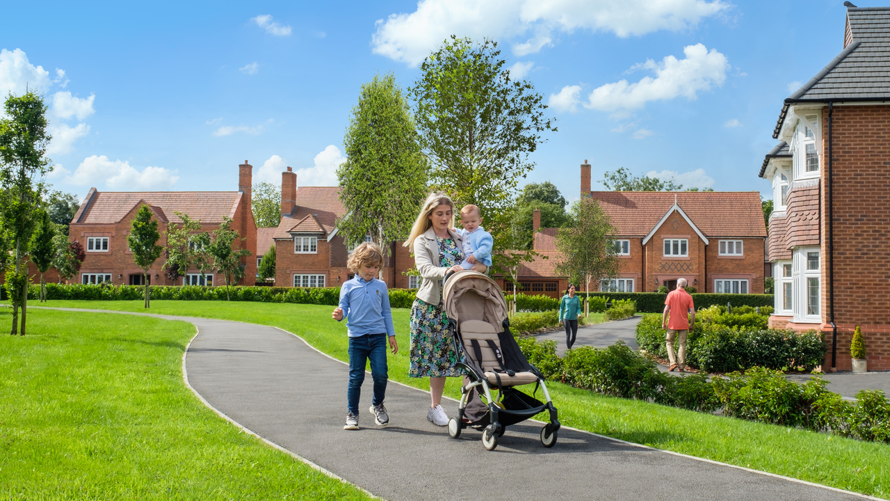 Woman and her children walking through a Redrow development