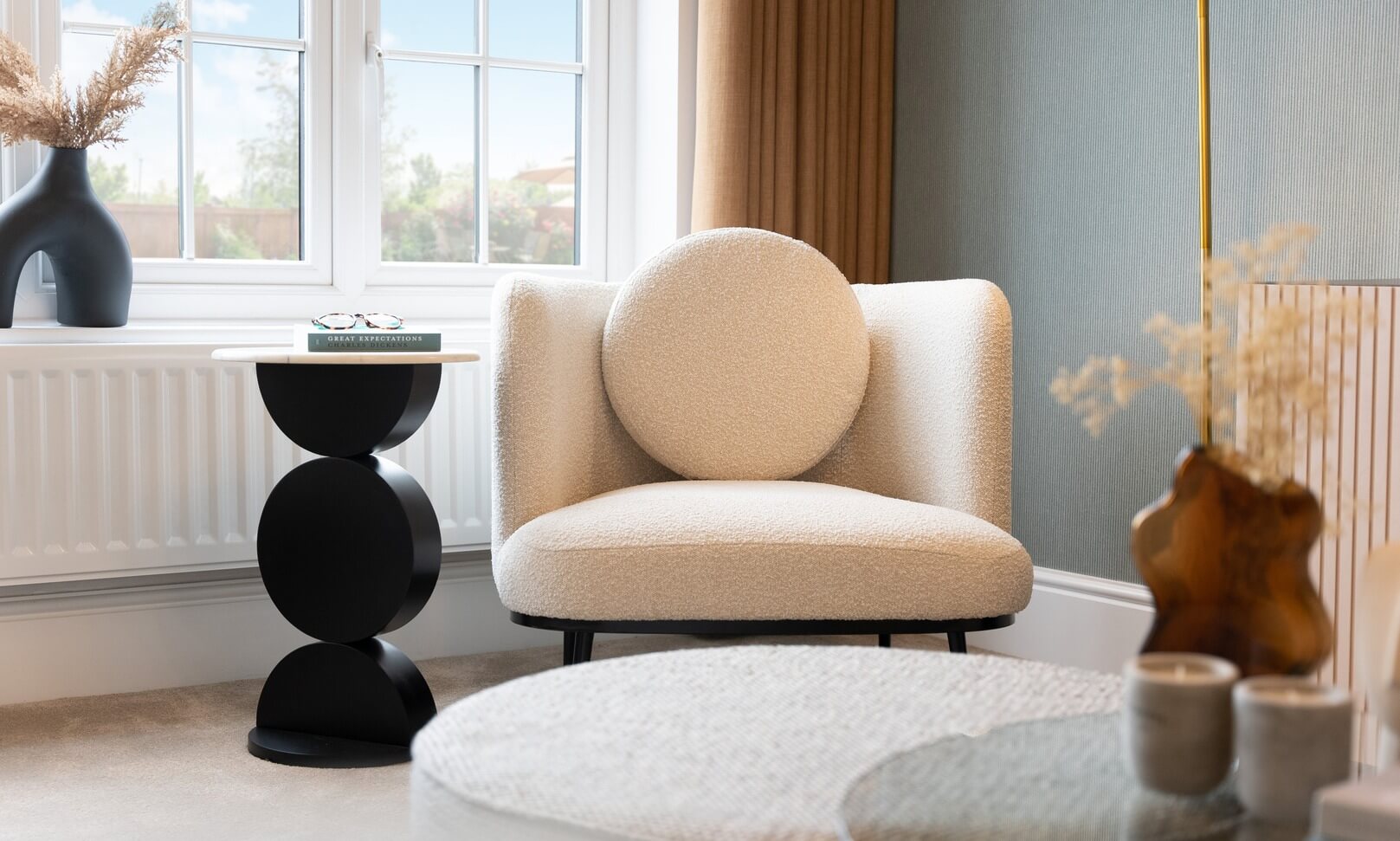 A modern and beautiful house interior with white sofa chair and decorations surrounding the area.