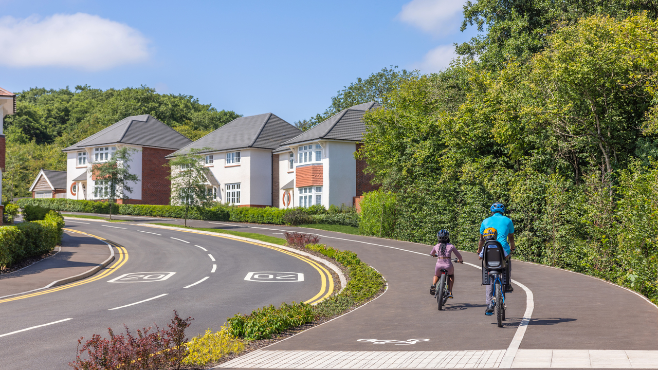 Father and children riding bikes on a cycle path