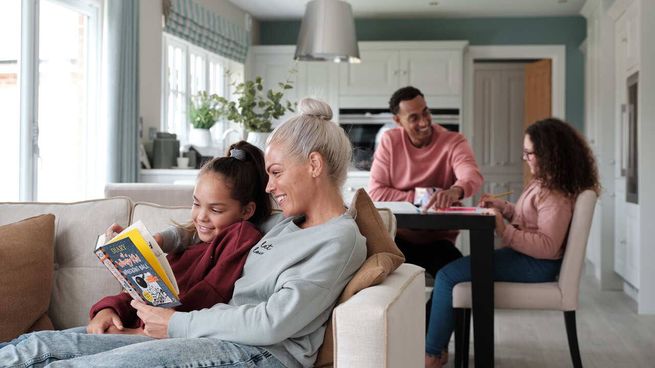 Family relaxing in their light-filled kitchen, dining and family area