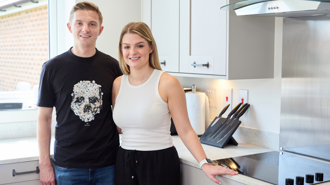 Young couple standing in their new kitchen