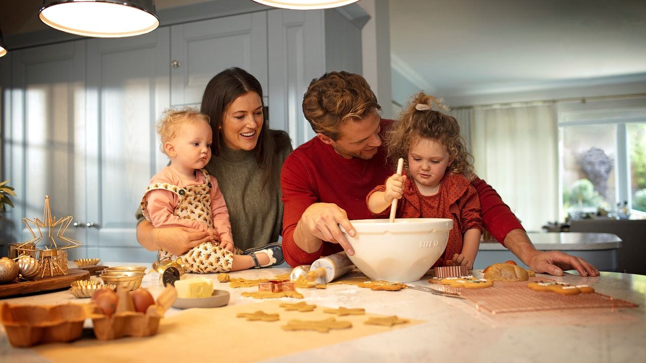 Family with two children baking together