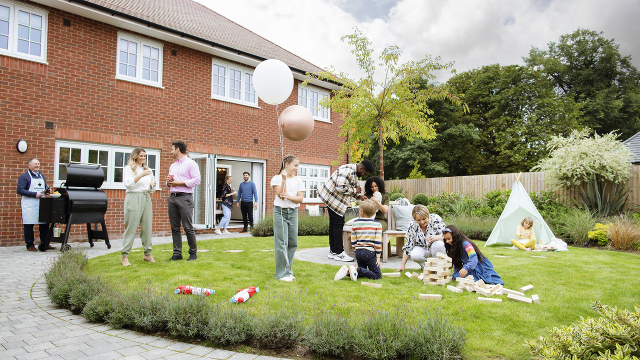 Family and friends having a BBQ in the garden