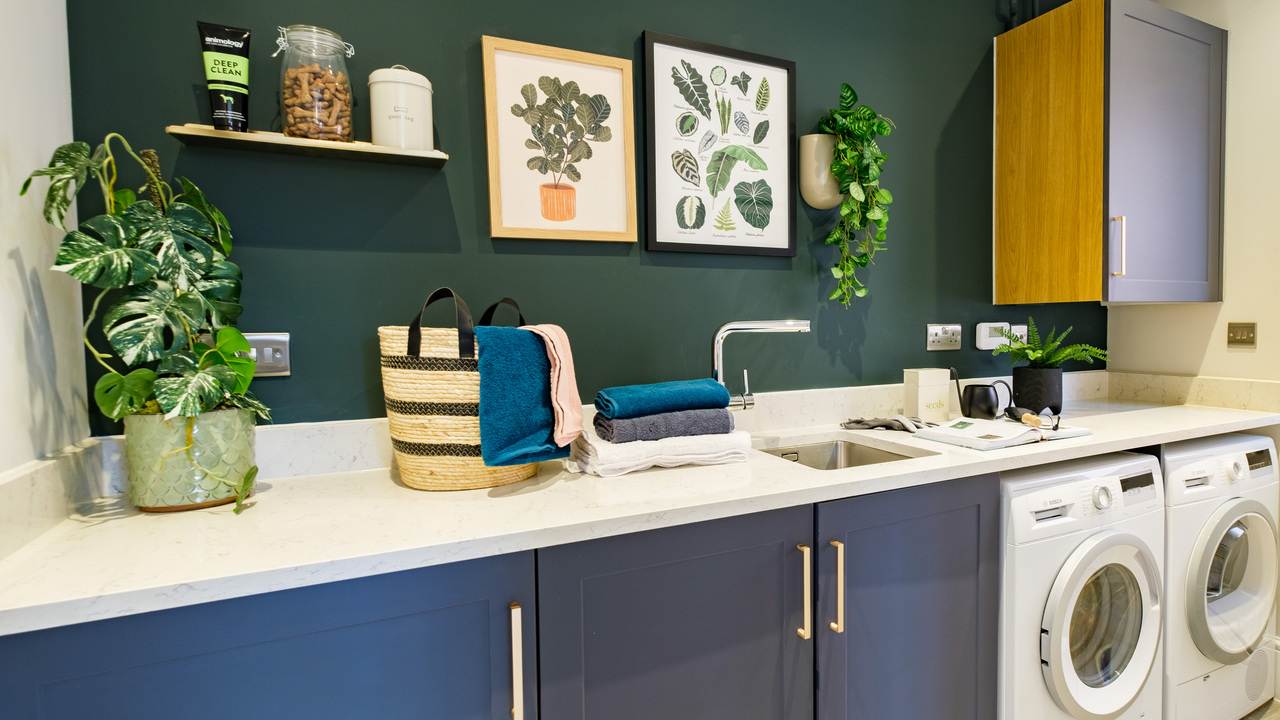 Utility room with dark blue units and walls