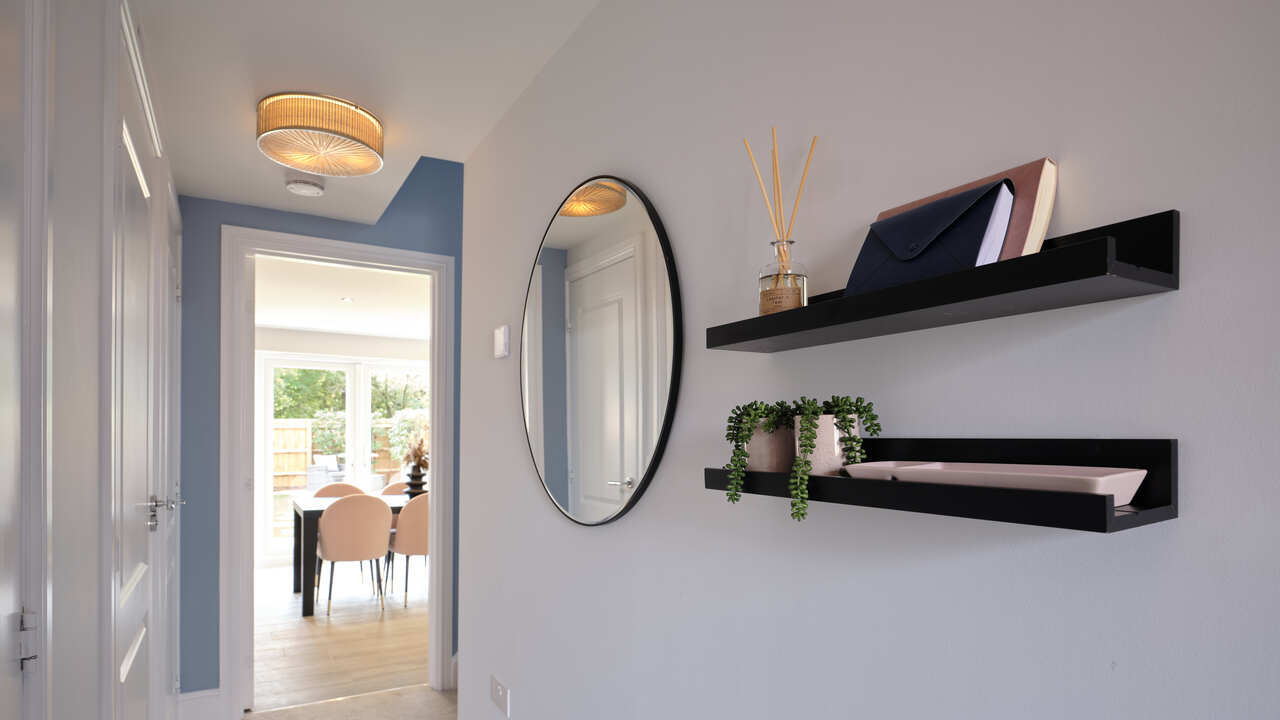 Picture shelves and a mirror in a hallway