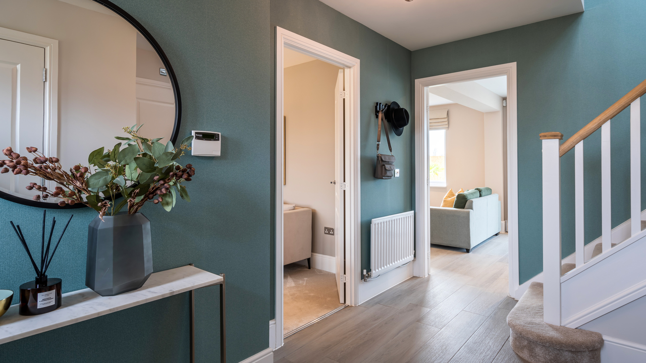 Two doorways leading off a hallway with teal walls