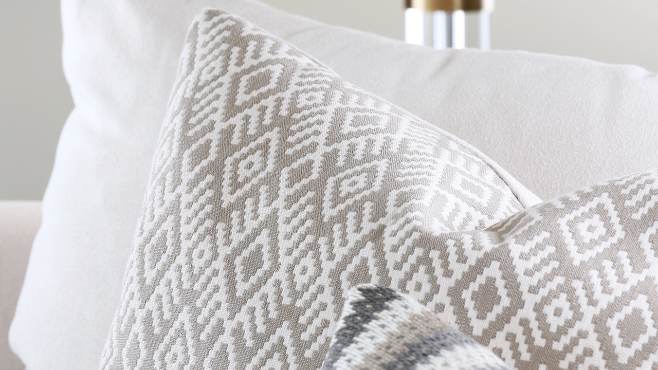 Scandinavian-style patterned cushion on a white couch