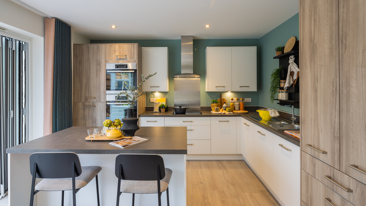 Modern kitchen with a mix of wooden and white units, a central island and barstools