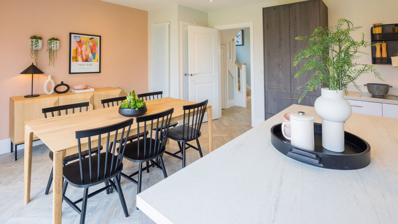 Kitchen and dining area featuring a wooden dining table and black chairs