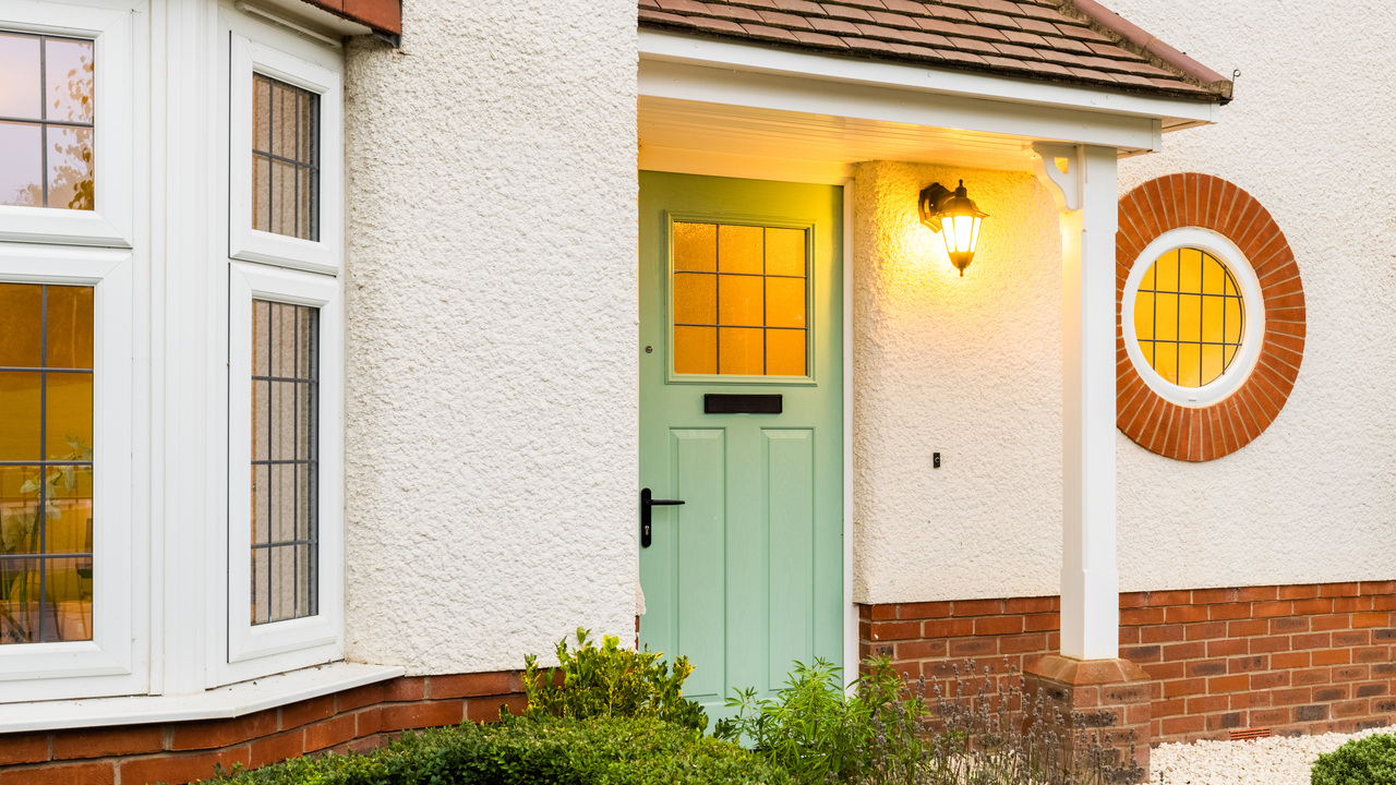 Light green door on an Arts and Crafts style home