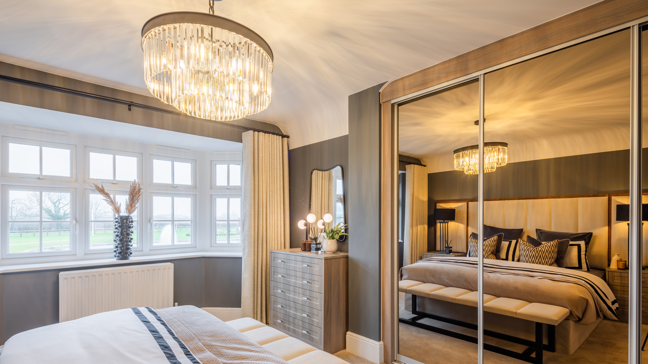 Bedroom with mirrored wardrobes and chandelier