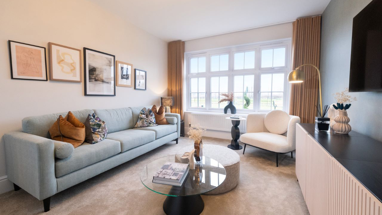 Classically designed lounge featuring a powder blue mid-century style sofa and a chic glass coffee table 