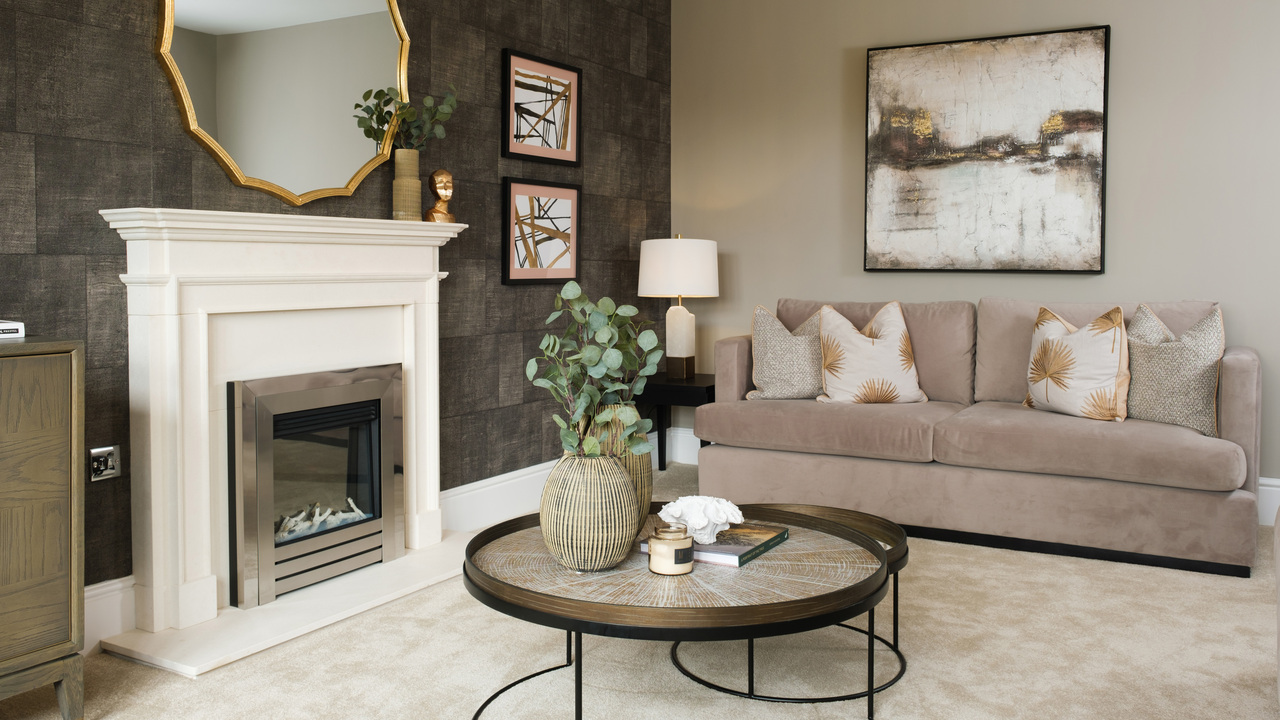 Living room decorated in a soft glam style, with textured wallpaper and a gold mirror