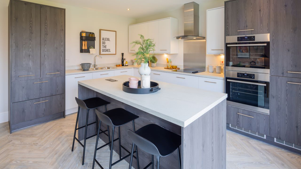 Stylish kitchen with a mix of wood and white units and a large kitchen island 