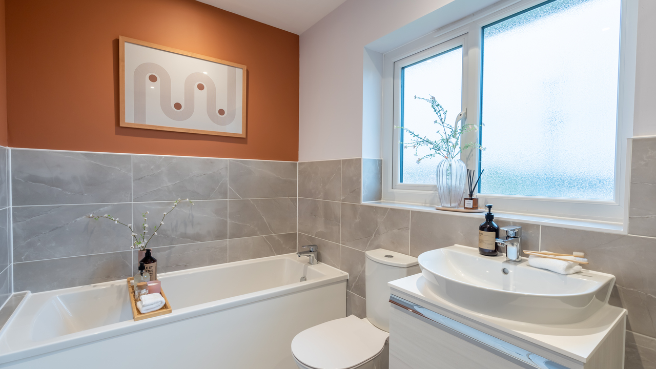 White bathroom with orange feature wall