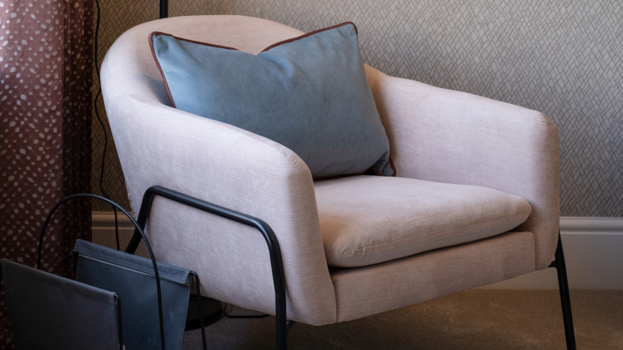 Pale pink easy chair with grey cushion