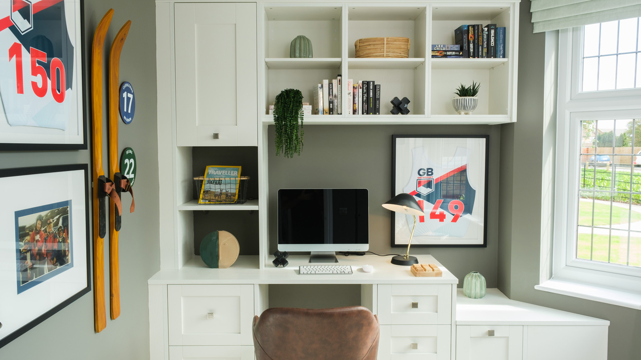 Home office with built in desk and bookcase wall
