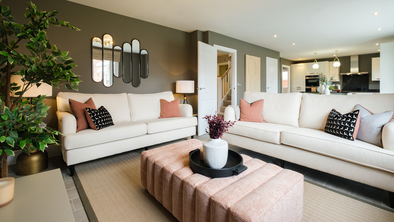 Beautifully designed lounge with dark walls and cream sofas